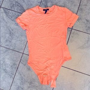 A light pink short sleeve body suit